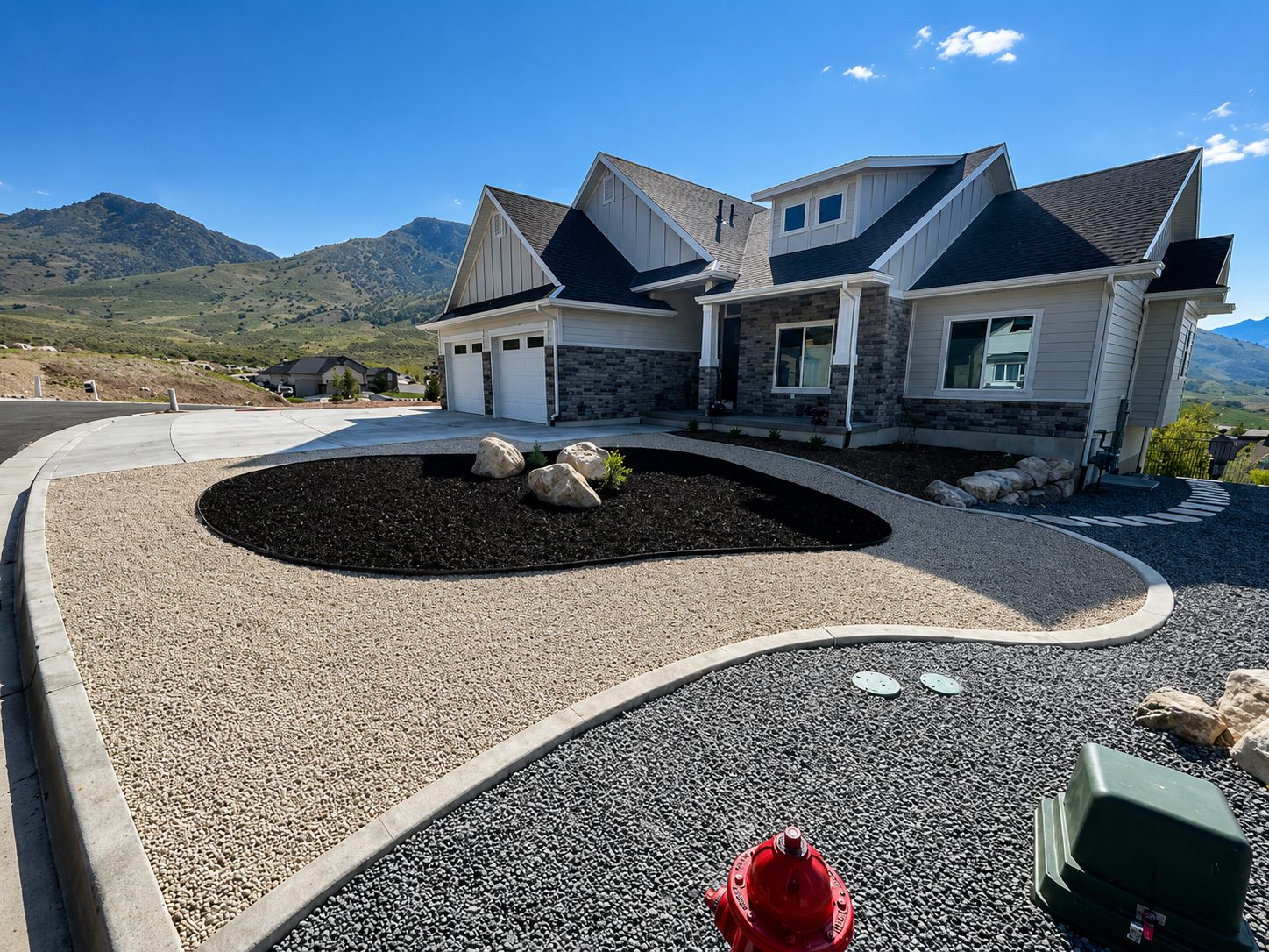 Water-wise front yard landscaping with rock, boulders, and mountain views in Northern Utah